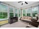 Inviting sunroom with ample natural light, comfortable seating, and a decorative fireplace at 5209 Thistleby Rd, Fuquay Varina, NC 27526