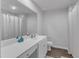 This bathroom features a shower with white shower curtains, vinyl flooring, and an extended vanity area at 536 Gusty Ln, Zebulon, NC 27597