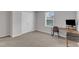 This bedroom features a large closet, plush carpet flooring, neutral walls, and a convenient workspace area at 536 Gusty Ln, Zebulon, NC 27597