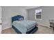 This bedroom features plush carpet flooring, neutral walls, and natural light streaming through the window at 536 Gusty Ln, Zebulon, NC 27597