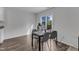 Dining area with wood floors, a dark table with chairs and a view of the backyard through the sliding glass doors at 536 Gusty Ln, Zebulon, NC 27597