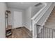 Inviting entryway with hardwood floors, coat rack, and staircase leading to the upper level at 536 Gusty Ln, Zebulon, NC 27597