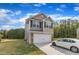Two-story home featuring a two-car garage, neutral siding, and large lawn at 536 Gusty Ln, Zebulon, NC 27597