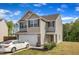 Two-story home featuring a two-car garage, neutral siding, and nicely trimmed landscaping at 536 Gusty Ln, Zebulon, NC 27597