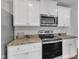 Close-up of the kitchen with granite countertops and stainless steel range and microwave at 536 Gusty Ln, Zebulon, NC 27597