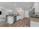 Kitchen featuring granite countertops, stainless steel appliances, island, and grey sectional view at 536 Gusty Ln, Zebulon, NC 27597