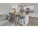 Kitchen featuring granite countertops, stainless steel appliances, island and grey bar stools at 536 Gusty Ln, Zebulon, NC 27597