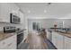 Bright, open kitchen with stainless steel appliances, granite countertops, and access to the outdoor space at 536 Gusty Ln, Zebulon, NC 27597