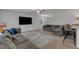 Open living room with a large grey sectional sofa and a flat screen television above a grey and white rug at 536 Gusty Ln, Zebulon, NC 27597
