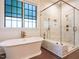 Bright bathroom showcasing a soaking tub and glass-enclosed walk-in shower at 602 Shelley Rd, Raleigh, NC 27609