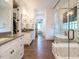 Elegant bathroom with dual vanities, glass shower, soaking tub, and modern fixtures at 602 Shelley Rd, Raleigh, NC 27609