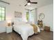 Bright bedroom with neutral walls, hardwood floors, ceiling fan, and a comfortable, well-lit atmosphere at 602 Shelley Rd, Raleigh, NC 27609