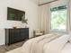 Bedroom showcasing a large window, television, dresser, and comfortable chair at 602 Shelley Rd, Raleigh, NC 27609