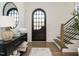 Welcoming foyer with a decorative arched front door, hardwood floors, and stylish console table decor at 602 Shelley Rd, Raleigh, NC 27609