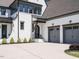 A beautiful white brick home with a two-car garage, a well-manicured lawn, and a charming front entrance at 602 Shelley Rd, Raleigh, NC 27609