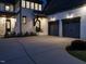 A beautiful white brick home with a two-car garage, a well-manicured lawn, and a charming front entrance at dusk at 602 Shelley Rd, Raleigh, NC 27609