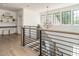 Bright foyer with wooden floors and railing, black iron balusters, and a geometric light fixture hanging above at 602 Shelley Rd, Raleigh, NC 27609