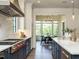 Open-concept kitchen featuring chef-grade range and adjacent dining room at 602 Shelley Rd, Raleigh, NC 27609