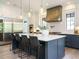 Modern kitchen with stainless steel appliances and large center island at 602 Shelley Rd, Raleigh, NC 27609