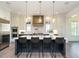 Modern kitchen with stainless steel appliances and large center island at 602 Shelley Rd, Raleigh, NC 27609