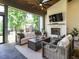 Inviting outdoor living area boasts a fireplace, comfortable seating, and a view of the landscaped yard at 602 Shelley Rd, Raleigh, NC 27609
