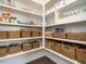 Organized pantry featuring built-in shelving and wicker baskets for storage at 602 Shelley Rd, Raleigh, NC 27609