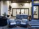 Covered patio area with a fireplace, television, and comfortable seating at 602 Shelley Rd, Raleigh, NC 27609