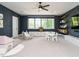 Expansive playroom with dark blue walls, cabinets, floating shelves, ceiling fan, and play structures at 602 Shelley Rd, Raleigh, NC 27609