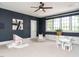 Playroom with dark blue walls, storage, seating and a play area with structures for  at 602 Shelley Rd, Raleigh, NC 27609