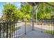 View of the community from the balcony with black metal railings and lush trees, perfect for enjoying the outdoors at 607 Smedes Place # B, Raleigh, NC 27605