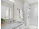 Modern bathroom with marble vanity, chrome fixtures, a glass-enclosed shower, and subway tile at 607 Smedes Place # B, Raleigh, NC 27605