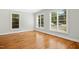 Well-lit bedroom with hardwood floors, white trim, and multiple windows for ample natural light at 607 Smedes Place # B, Raleigh, NC 27605