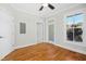 Bedroom features hardwood floors, a ceiling fan, a window, and doors leading to other rooms or bathrooms at 607 Smedes Place # B, Raleigh, NC 27605