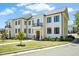 Elegant white building featuring a balcony and well-manicured landscaping at 607 Smedes Place # B, Raleigh, NC 27605