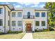 Stately white building entrance featuring a wooden door, balcony, and classic architectural details at 607 Smedes Place # B, Raleigh, NC 27605