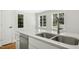 Bright kitchen featuring a marble countertop, stainless steel sink, and windows providing natural light at 607 Smedes Place # B, Raleigh, NC 27605