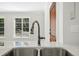 Close-up on a kitchen sink with a modern faucet and marble countertop, complemented by bright windows at 607 Smedes Place # B, Raleigh, NC 27605