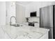 Modern kitchen showcasing marble countertops, stainless steel appliances, and sleek white cabinetry at 607 Smedes Place # B, Raleigh, NC 27605