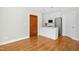 Efficient kitchenette featuring white cabinets, stainless steel appliances, and hardwood flooring at 607 Smedes Place # B, Raleigh, NC 27605