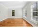 Bright living room featuring hardwood floors, white walls, and large windows with natural light at 607 Smedes Place # B, Raleigh, NC 27605