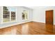 Inviting living space with beautiful hardwood floors, white walls, and natural light from large windows at 607 Smedes Place # B, Raleigh, NC 27605
