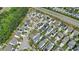Aerial view of the neighborhood with tree-lined street, homes with solar panels and sidewalks at 704 Moonbeam Dr, Raleigh, NC 27603