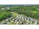 This is an aerial view of a neighborhood with trees, a pond, and sidewalks to enjoy the neighborhood at 704 Moonbeam Dr, Raleigh, NC 27603