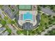 Bird's-eye view of a community pool, tennis courts, and a clubhouse, showcasing the outdoor amenities at 704 Moonbeam Dr, Raleigh, NC 27603