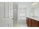 Bright bathroom with double vanity, soaking tub, and glass-enclosed shower at 704 Moonbeam Dr, Raleigh, NC 27603