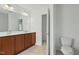 Bathroom boasts double sinks, wood cabinets, and tiled floor at 704 Moonbeam Dr, Raleigh, NC 27603