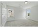 Bedroom featuring two windows providing natural light and neutral carpet at 704 Moonbeam Dr, Raleigh, NC 27603
