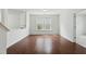 Hardwood floor bonus room with bright windows and neutral paint at 704 Moonbeam Dr, Raleigh, NC 27603