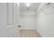 Bright, walk-in closet featuring wire shelving and neutral carpet at 704 Moonbeam Dr, Raleigh, NC 27603