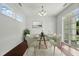 Bright dining room with glass table, white chairs, and sliding door access at 704 Moonbeam Dr, Raleigh, NC 27603